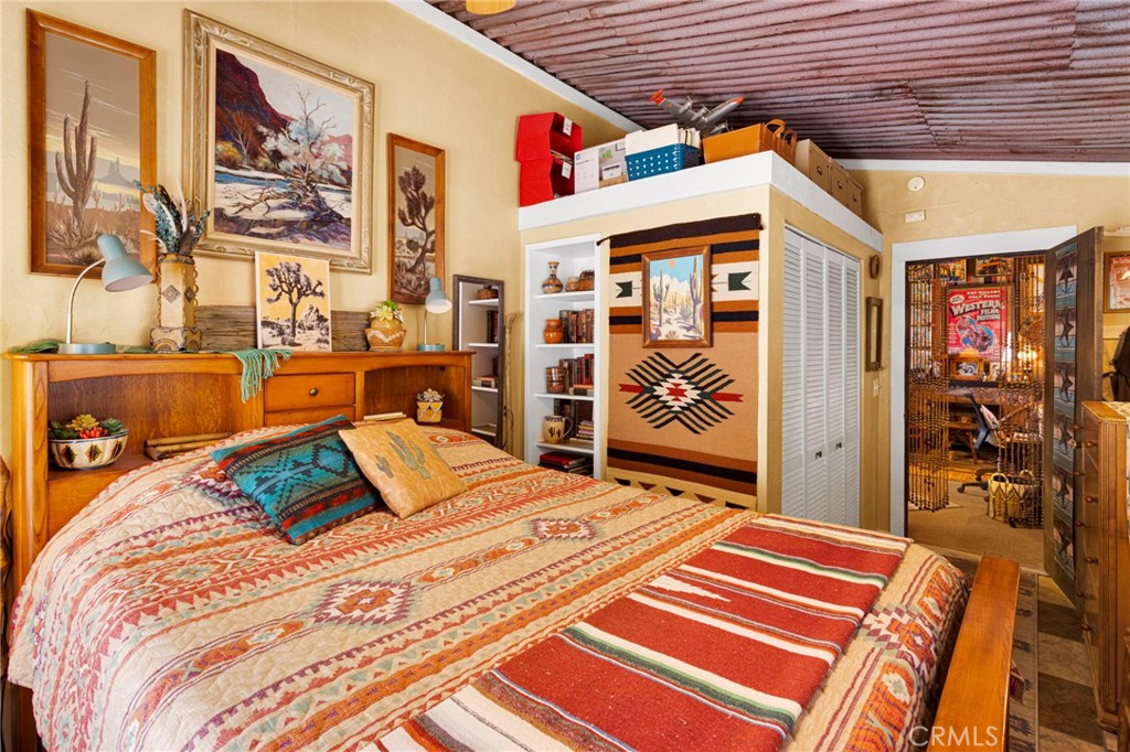 29229 Santa Rosa Road Lucerne Valley, CA 92356 - Photo 48 of 74 a bed sitting in a bedroom next to a window