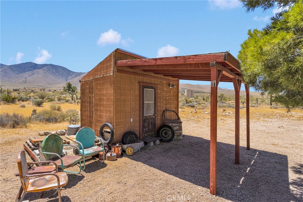 29229 Santa Rosa Road Lucerne Valley, CA 92356 - Photo 60 of 74 a view of a patio with chairs and a table