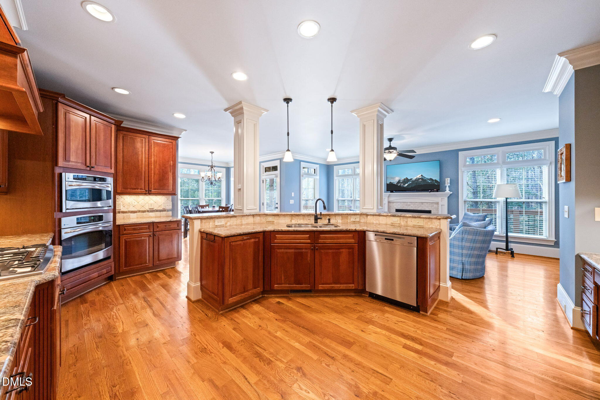 12313 The Gates Drive Raleigh, NC 27614 - Photo 19 of 78 a kitchen with stainless steel appliances kitchen island granite countertop a stove a sink a refrigerator and cabinets