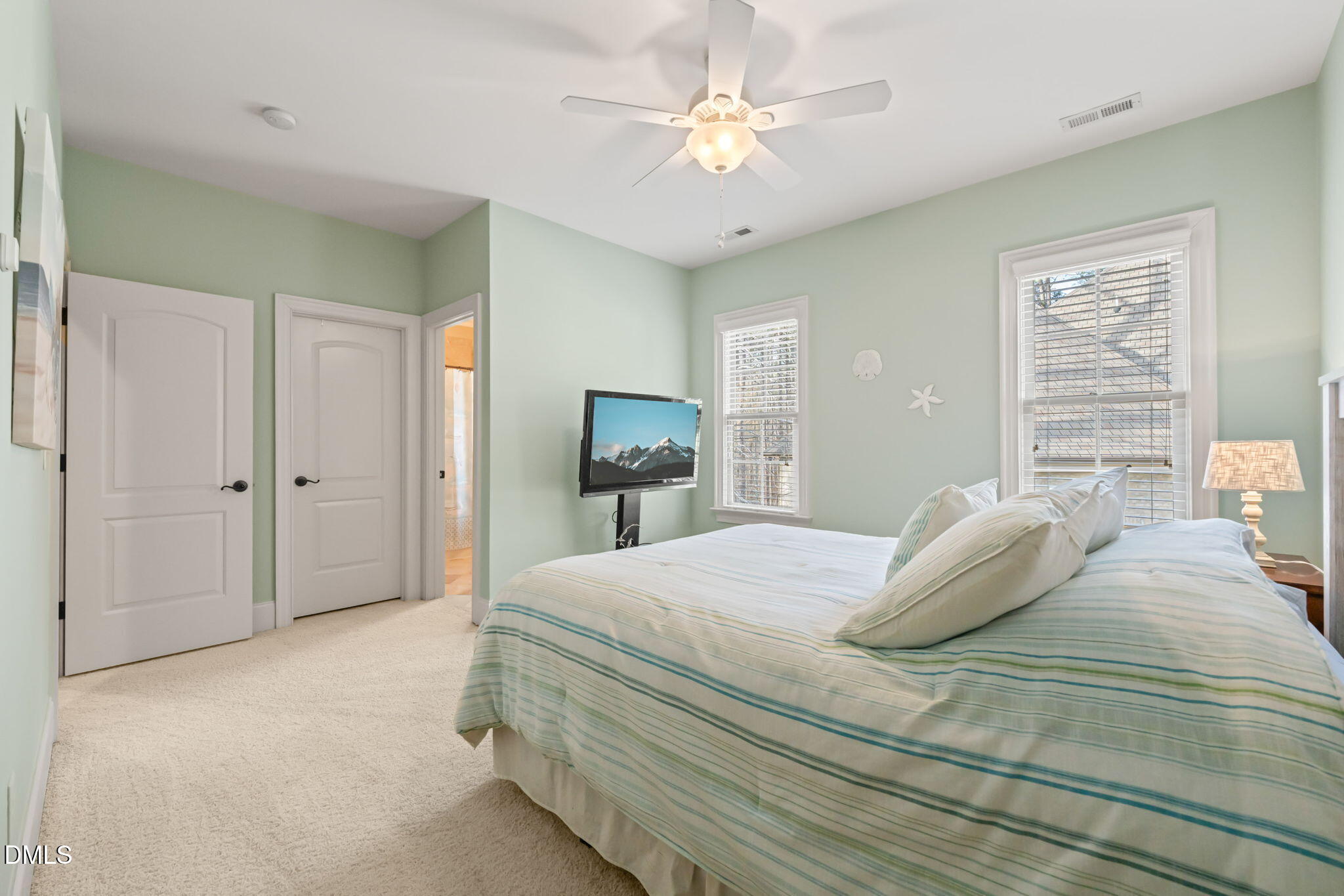 12313 The Gates Drive Raleigh, NC 27614 - Photo 36 of 78 a bedroom with a bed and a chandelier