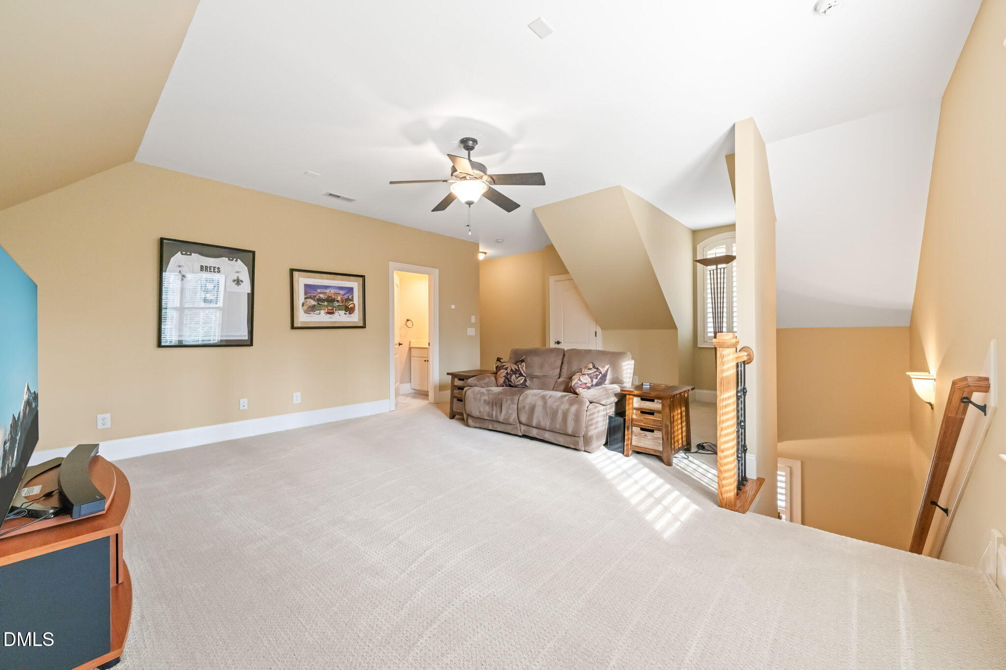 12313 The Gates Drive Raleigh, NC 27614 - Photo 51 of 78 a spacious bedroom with a bed a couch and a chandelier