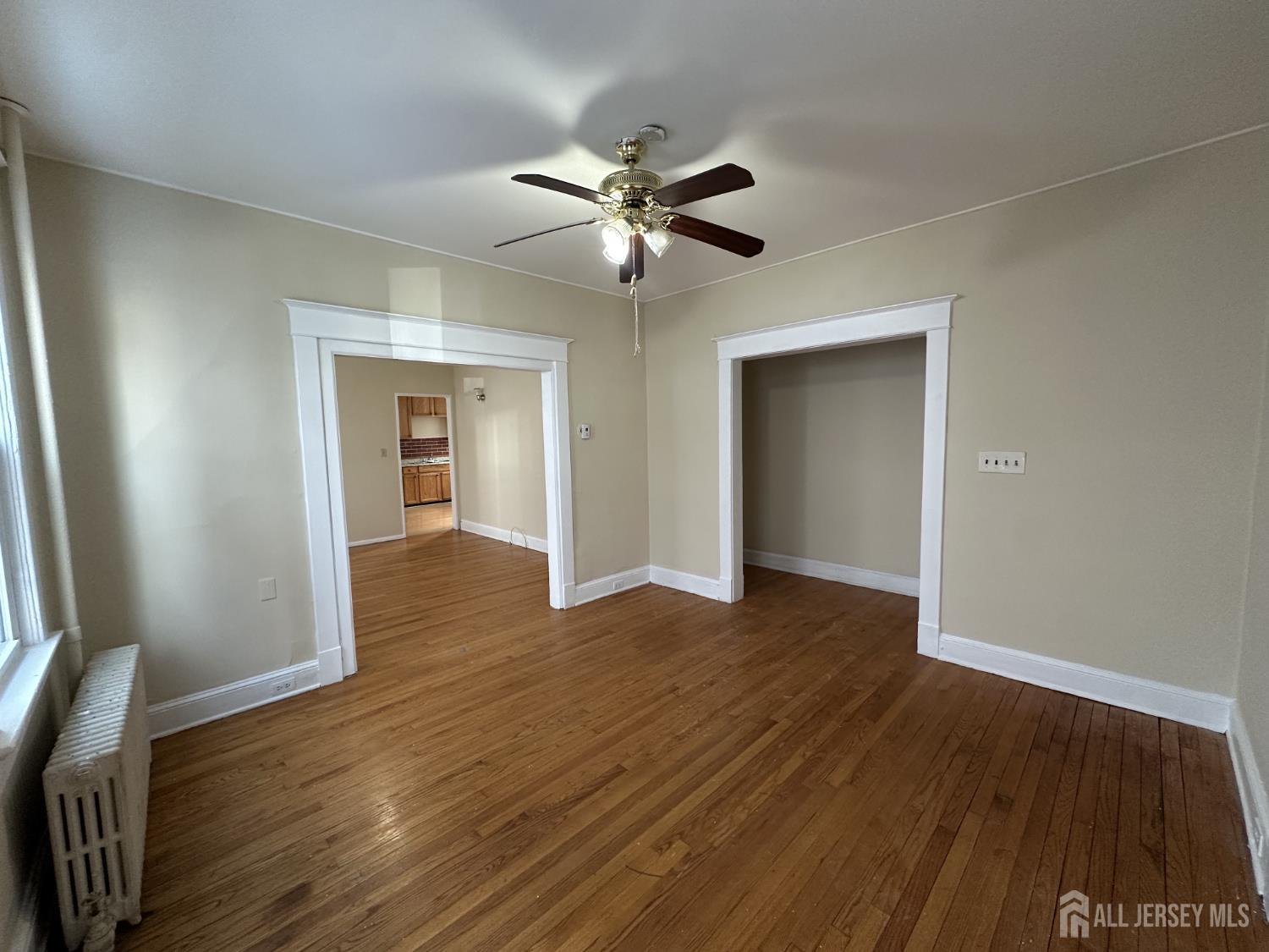 66 Louis Street New Brunswick, NJ 08901 - Photo 4 of 10 a view of an empty room with wooden floor