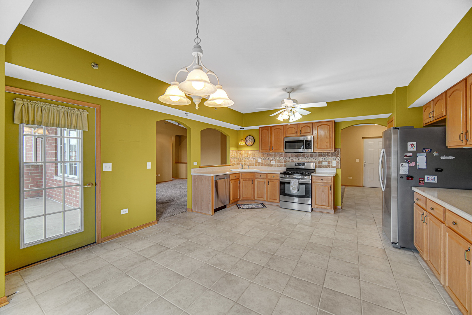 7920 Trinity Circle, Unit 4SW Tinley Park, IL 60487 - Photo 11 of 30 a large kitchen with a window and stainless steel appliances