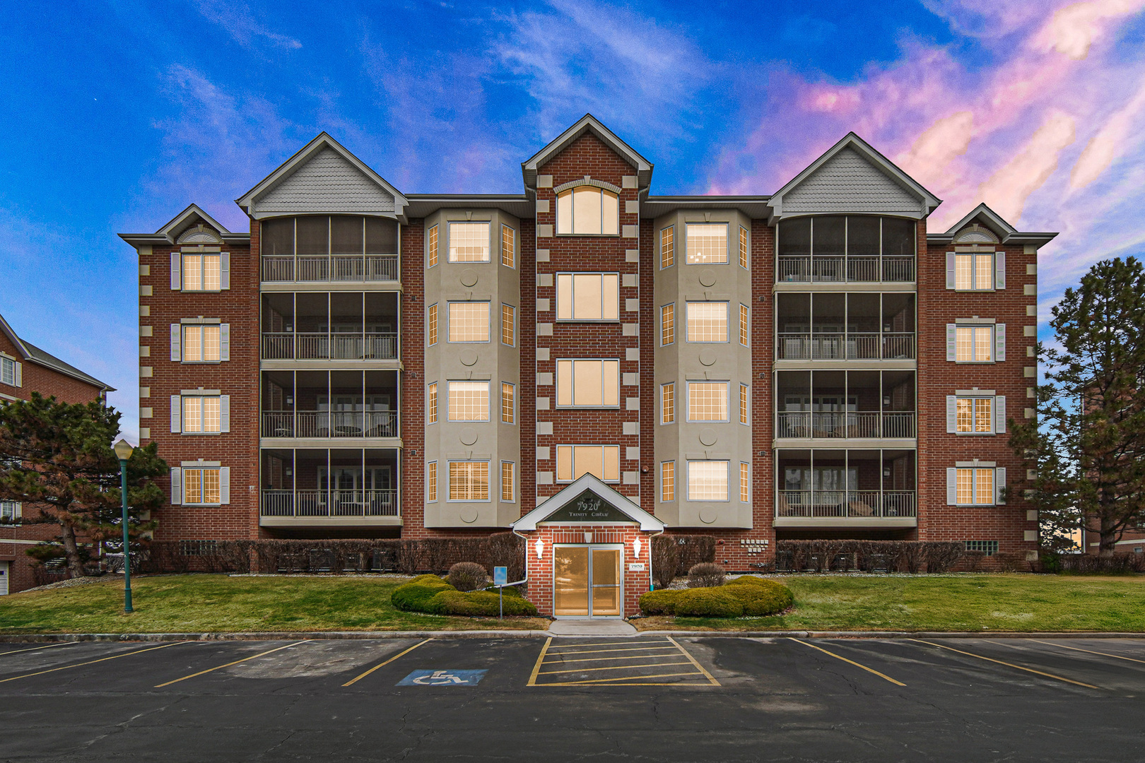 7920 Trinity Circle, Unit 4SW Tinley Park, IL 60487 - Photo 2 of 30 a front view of a residential apartment building with a yard