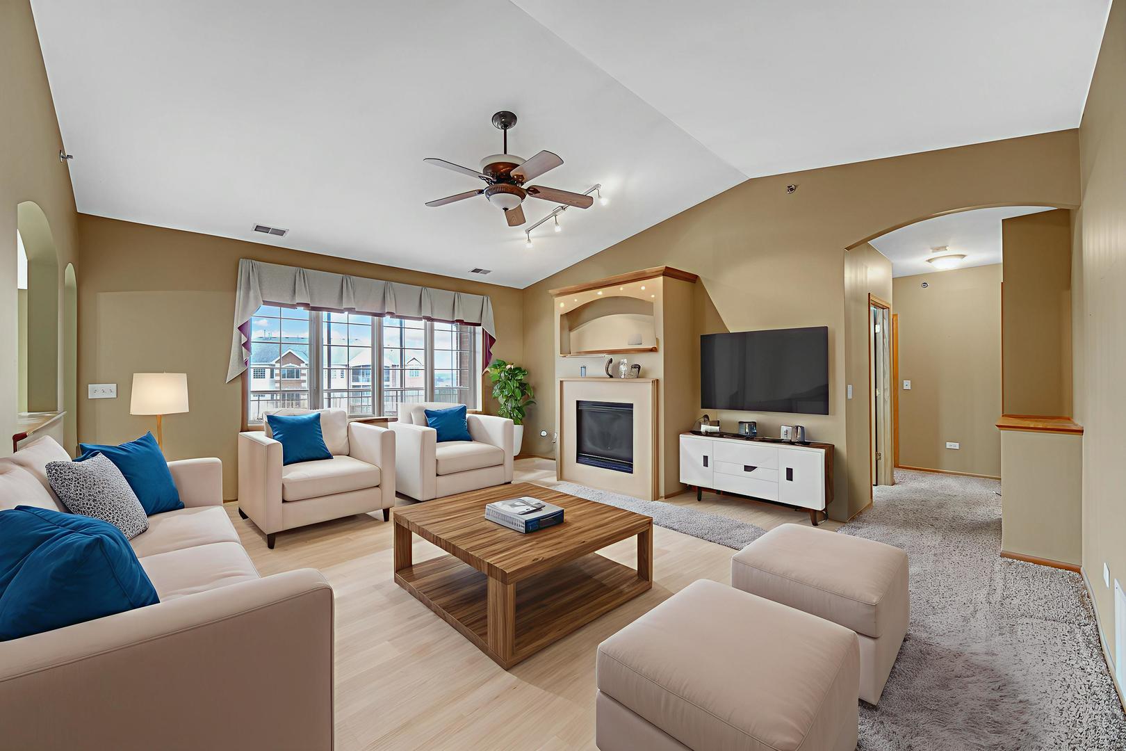 7920 Trinity Circle, Unit 4SW Tinley Park, IL 60487 - Photo 7 of 30 a living room with furniture a flat screen tv and a large window
