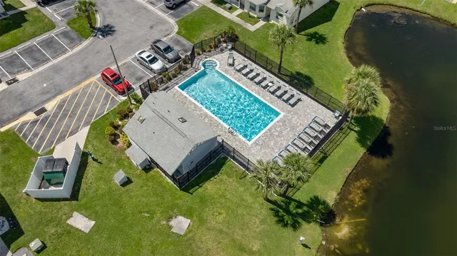 an aerial view of a house with swimming pool and outdoor space