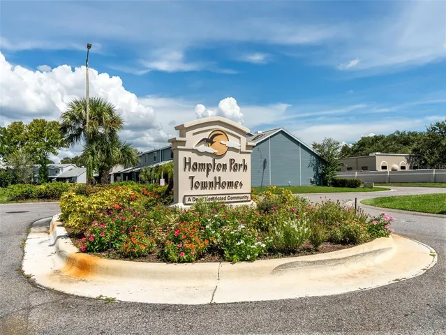a view of a house with a yard and potted plants