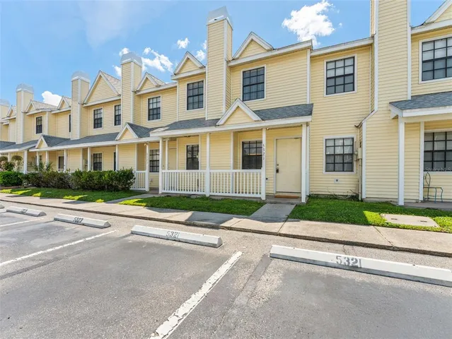 a view of a brick house next to a yard