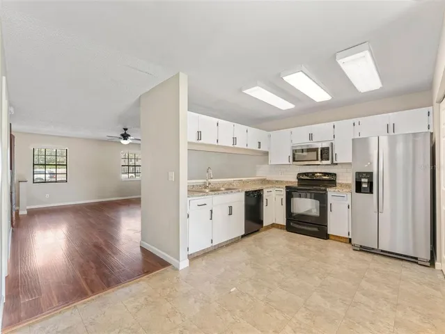 a kitchen with granite countertop cabinets and stainless steel appliances
