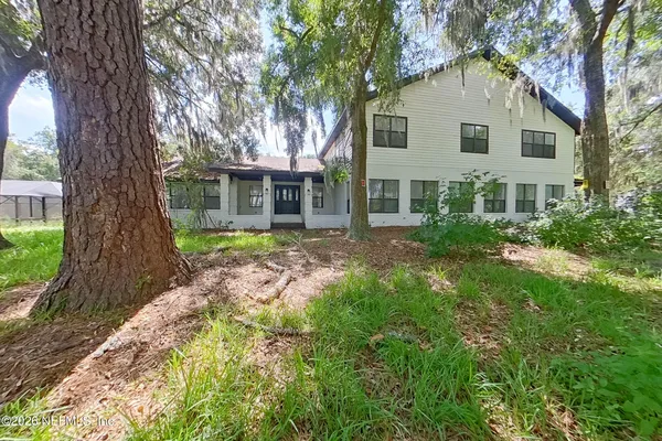 a front view of house with yard and green space