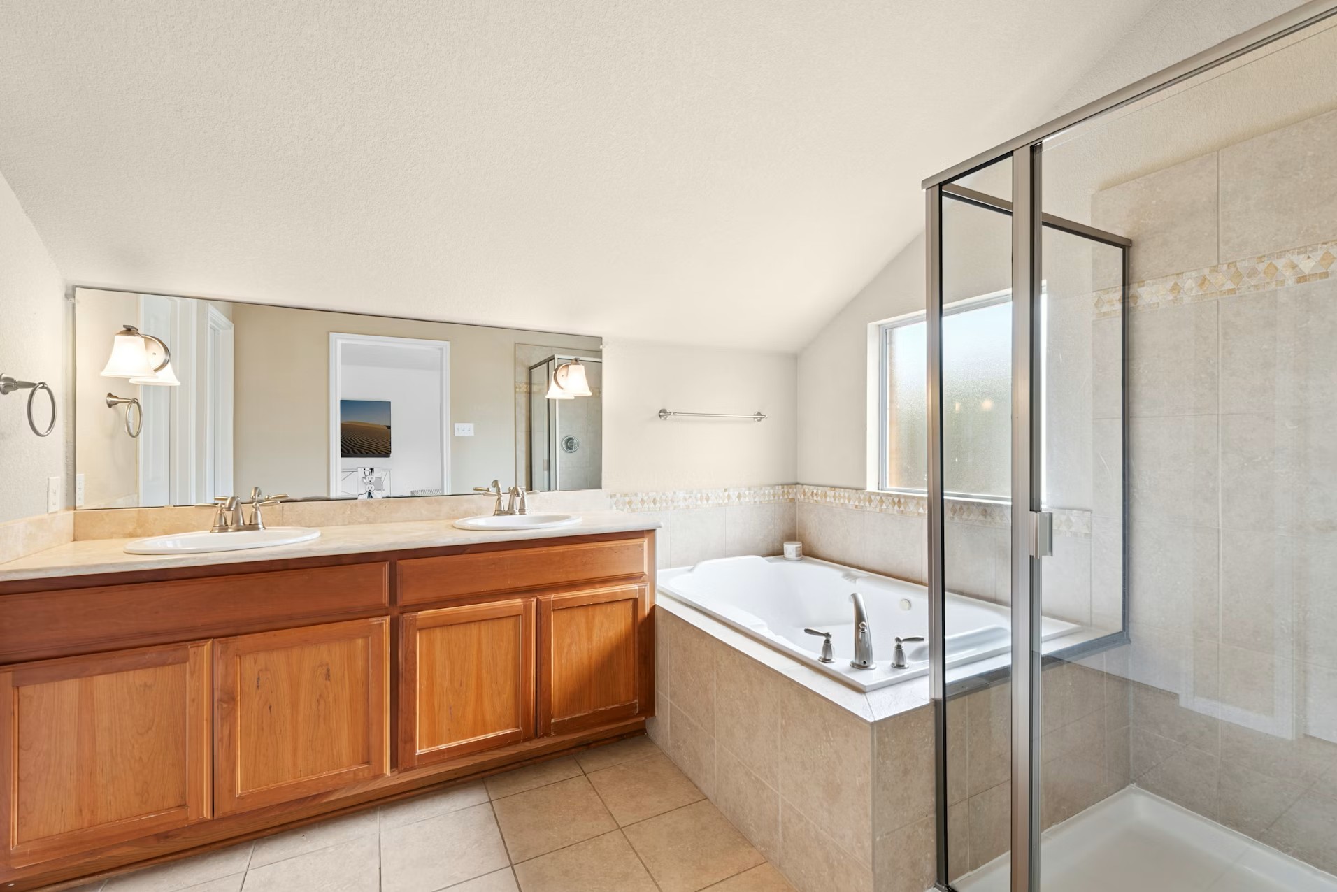 320 El Socorro Lane Austin, TX 78732 - Photo 34 of 40 a bathroom with a sink mirror and a bathtub