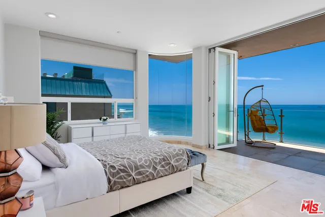 a bedroom with a bed and a mirror