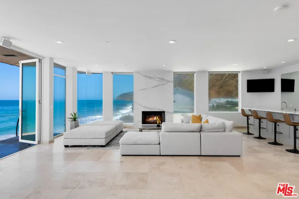 a living room with furniture and fireplace