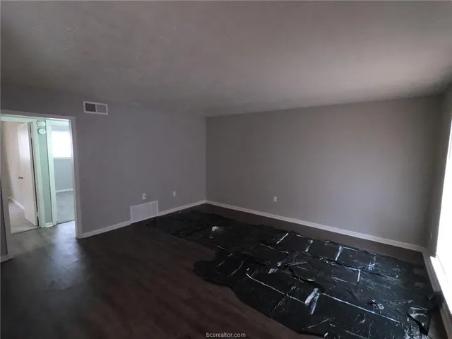 an empty room with wooden floor