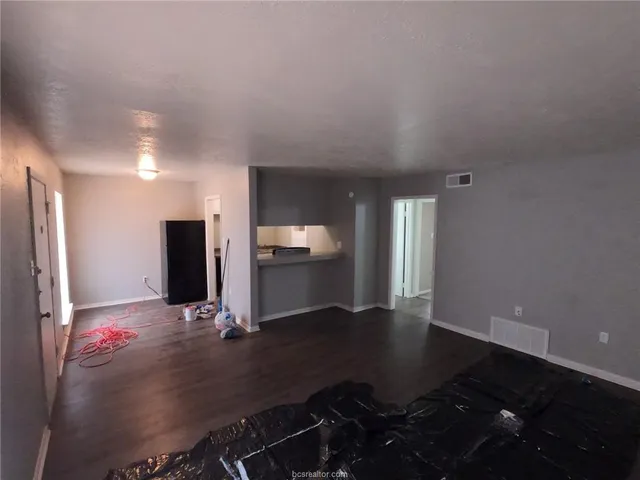 a view of kitchen with windows and refrigerator