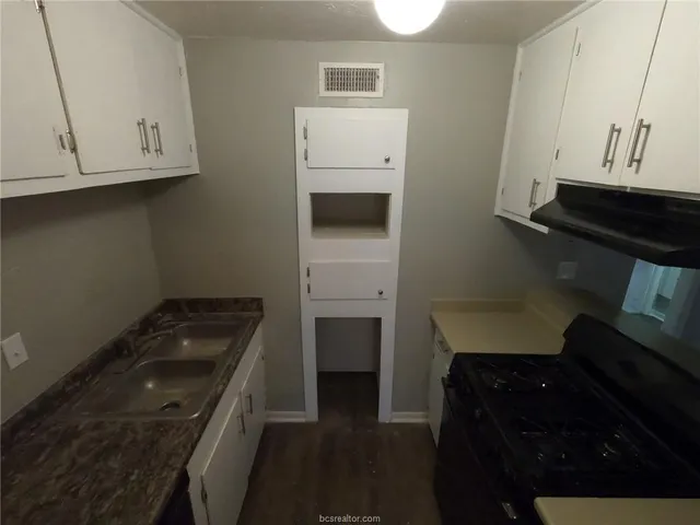 a kitchen with a sink and cabinets