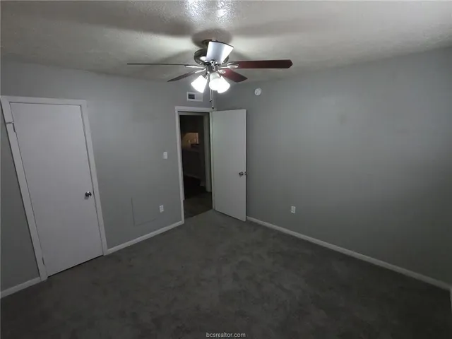 a view of an empty room with a fan