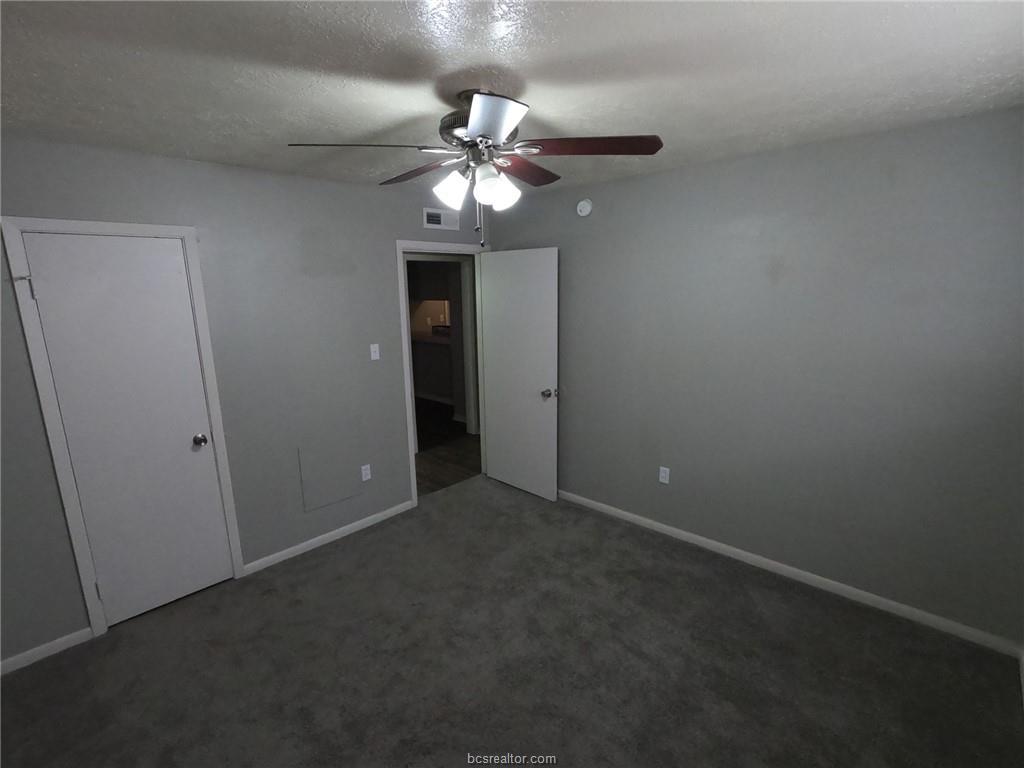 3300 South College Avenue, Unit A05 Bryan, TX 77801 - Photo 6 of 15 a view of an empty room with a fan
