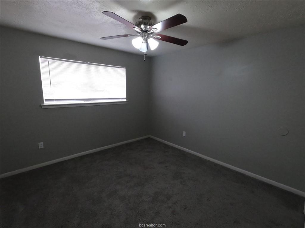 3300 South College Avenue, Unit A05 Bryan, TX 77801 - Photo 7 of 15 an empty room with a window