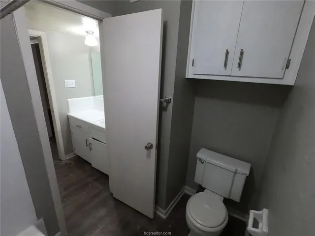 a bathroom with a toilet and a mirror