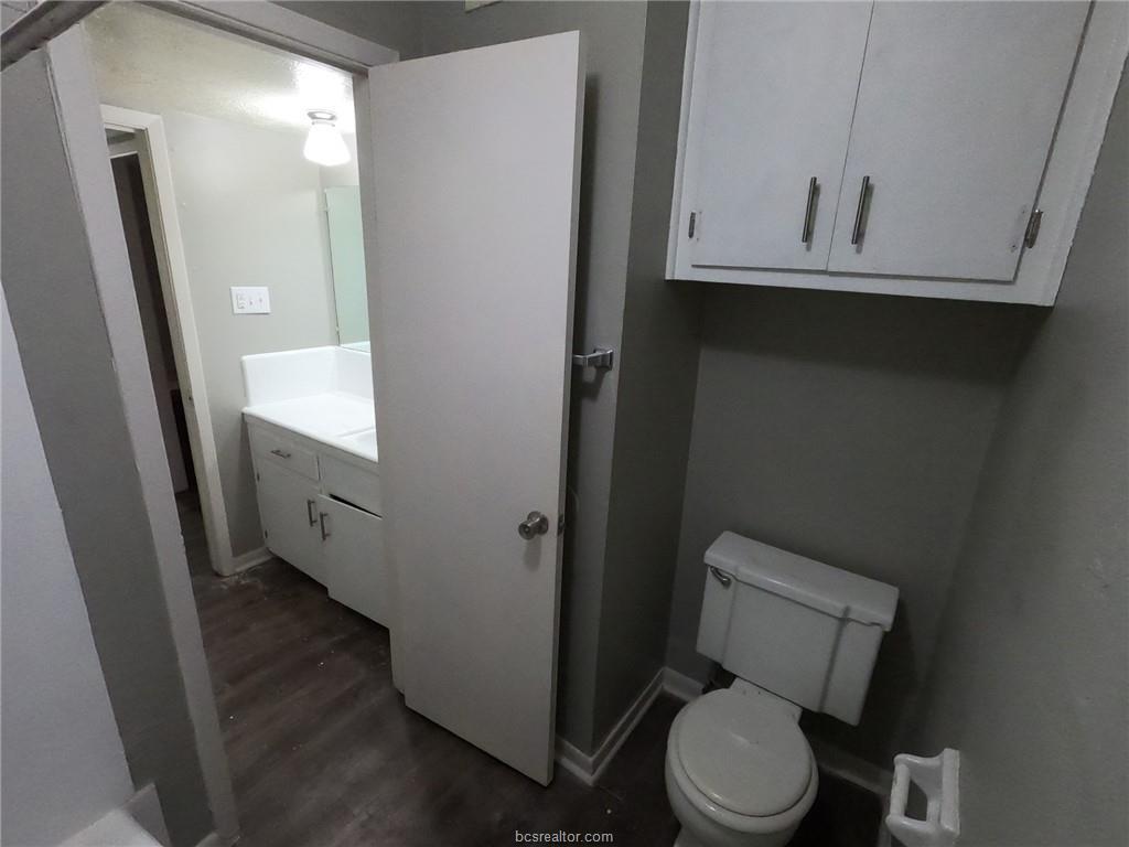 3300 South College Avenue, Unit A05 Bryan, TX 77801 - Photo 9 of 15 a bathroom with a toilet and a mirror