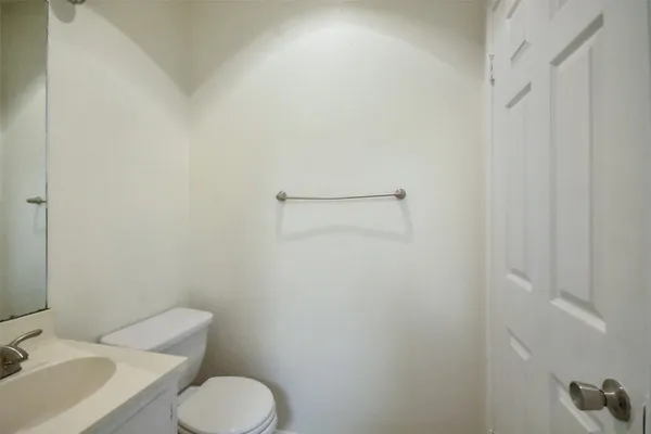 a white toilet sitting next to a bathroom sink