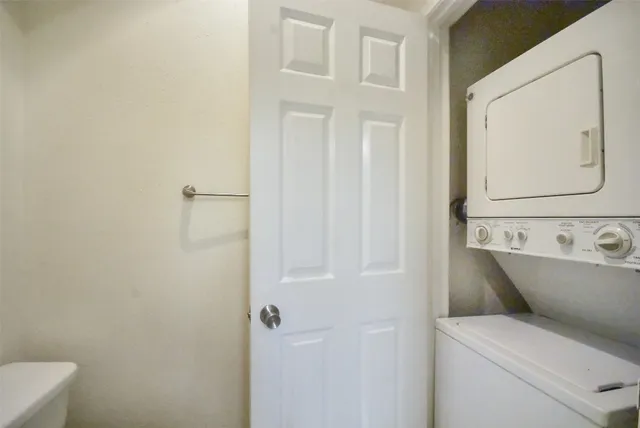 an empty room with wooden floor chandelier fan and windows