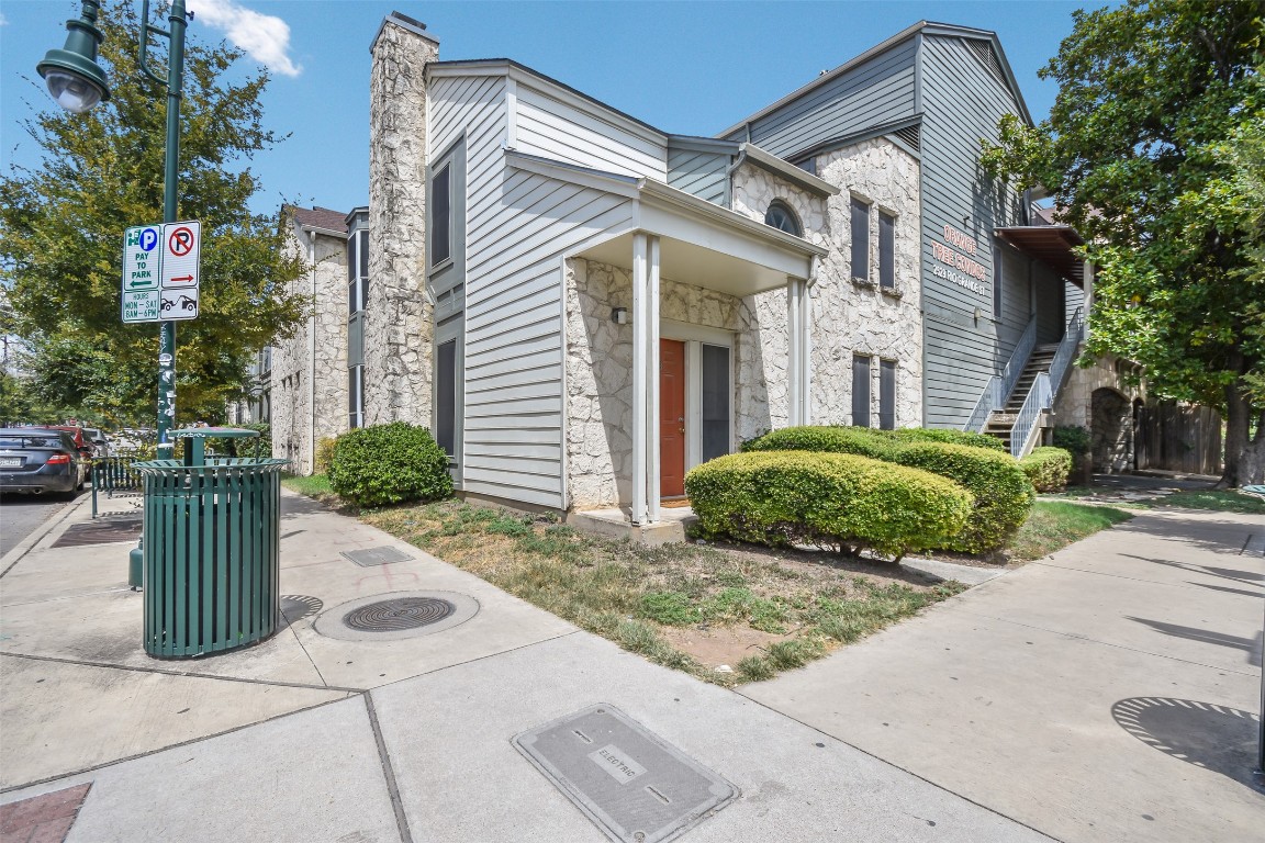2529 Rio Grande Street, Unit 85 Austin, TX 78705 - Photo 27 of 31 a view of a house with a small yard plants and a large tree