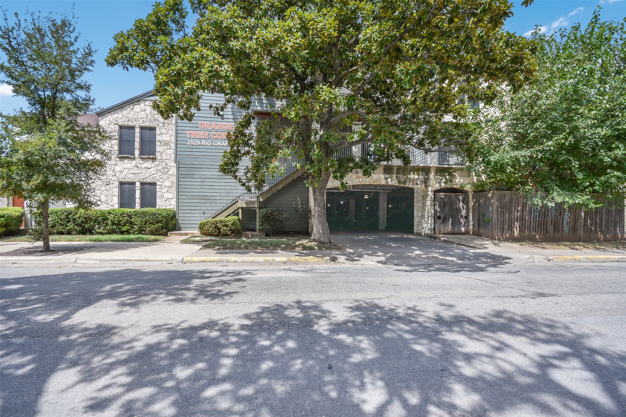 2529 Rio Grande Street, Unit 85 Austin, TX 78705 - Photo 28 of 31 a front view of a house with a yard and garage