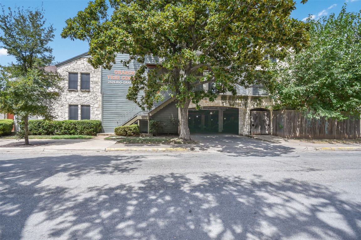 2529 Rio Grande Street, Unit 85 Austin, TX 78705 - Photo 28 of 31 a front view of a house with a yard and garage