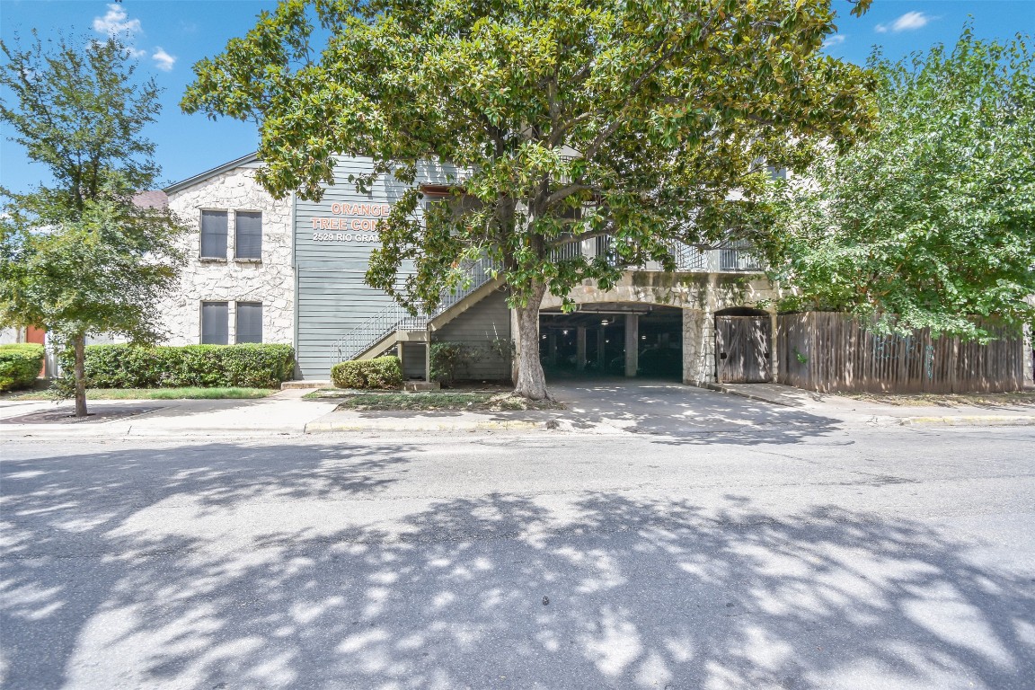 2529 Rio Grande Street, Unit 85 Austin, TX 78705 - Photo 29 of 31 a front view of a house with a yard and garage