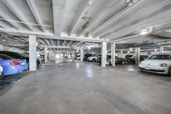 a view of parking area with garage