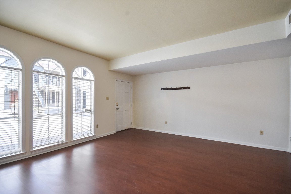 2529 Rio Grande Street, Unit 85 Austin, TX 78705 - Photo 4 of 31 an empty room with wooden floor and windows