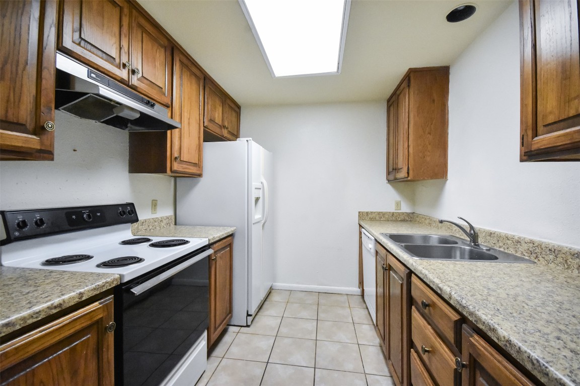 2529 Rio Grande Street, Unit 85 Austin, TX 78705 - Photo 8 of 31 a kitchen with stainless steel appliances granite countertop a sink stove and refrigerator