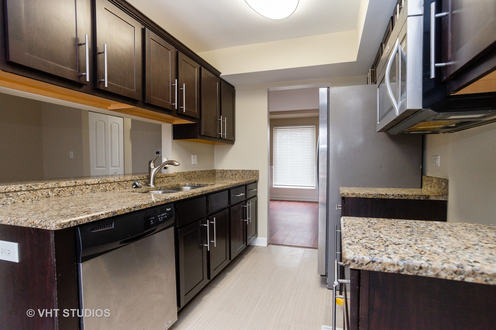 798 Roosevelt Road, Unit 1 Hanover Park, IL 60133 - Photo 4 of 10 a kitchen with stainless steel appliances granite countertop a sink stove and refrigerator