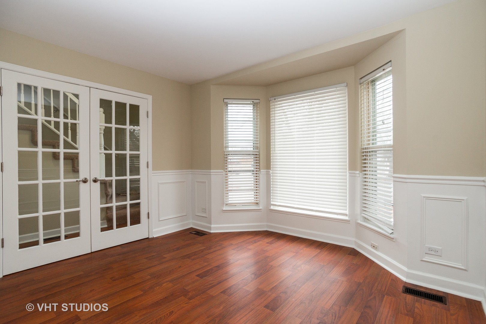 798 Roosevelt Road, Unit 1 Hanover Park, IL 60133 - Photo 5 of 10 an empty room with wooden floor and windows