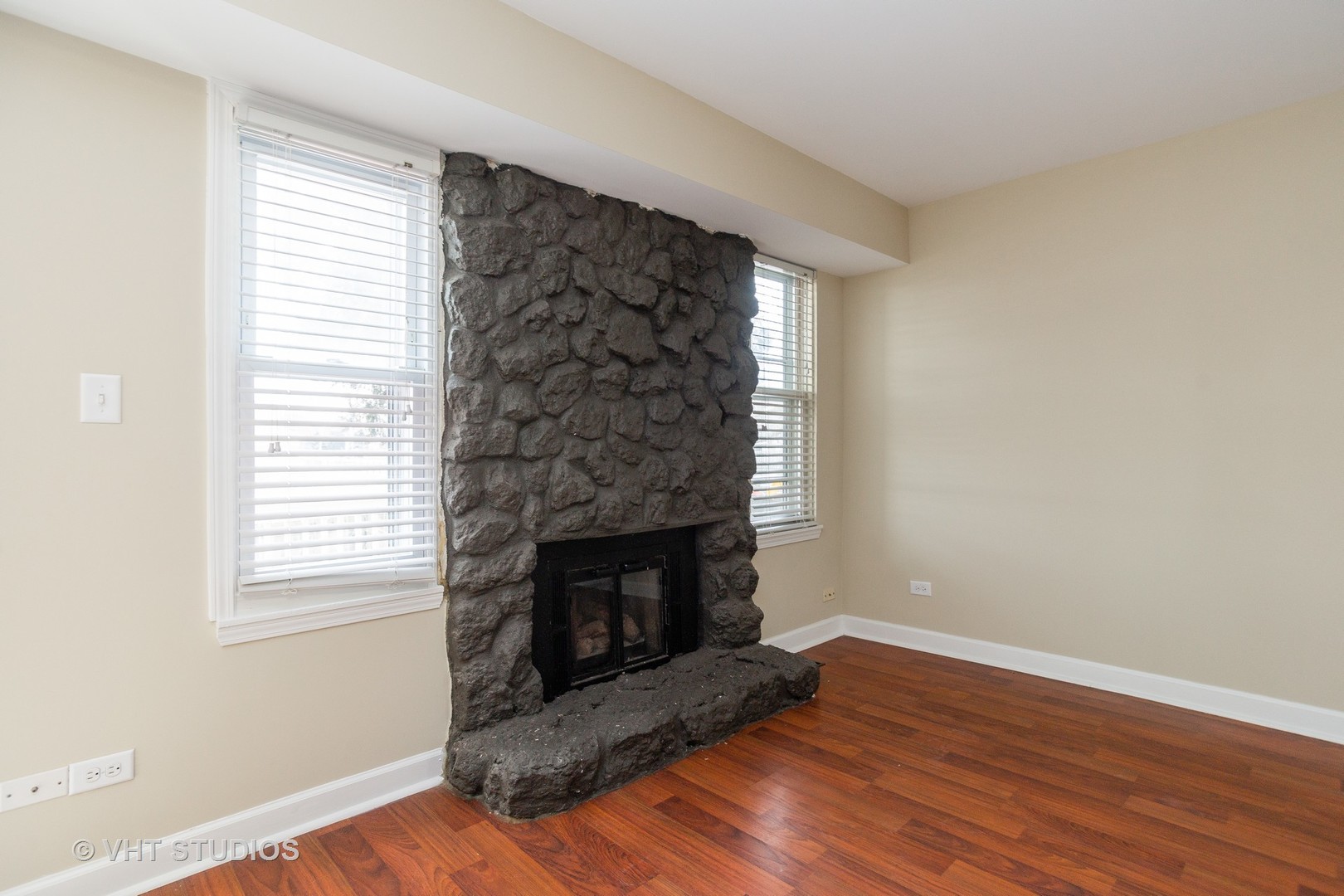 798 Roosevelt Road, Unit 1 Hanover Park, IL 60133 - Photo 6 of 10 a living room with a fireplace and wooden floor