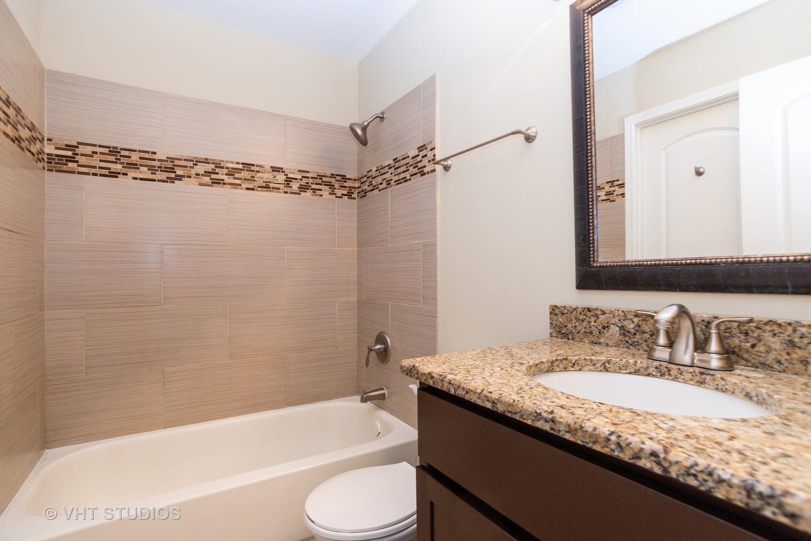 798 Roosevelt Road, Unit 1 Hanover Park, IL 60133 - Photo 10 of 10 a bathroom with a granite countertop sink toilet and shower