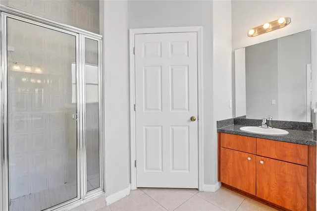 a bathroom with a granite countertop sink a mirror and a