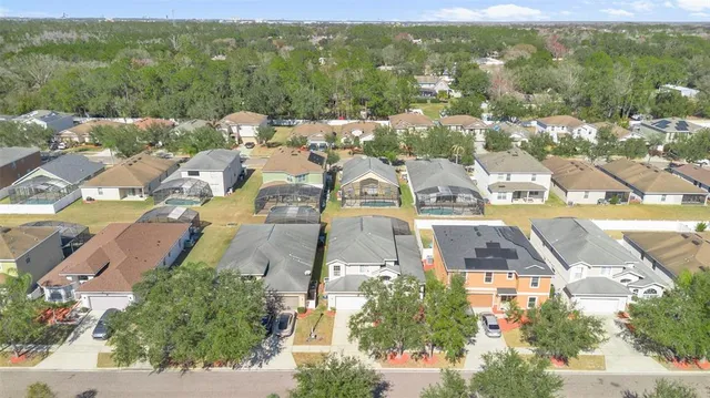 an aerial view of residential houses with outdoor space and street view