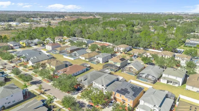 an aerial view of residential houses with outdoor space