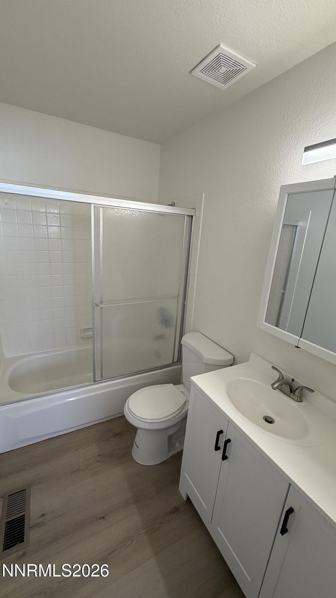 6451 Flower Street Reno, NV 89506 - Photo 11 of 14 a bathroom with a sink a toilet and shower