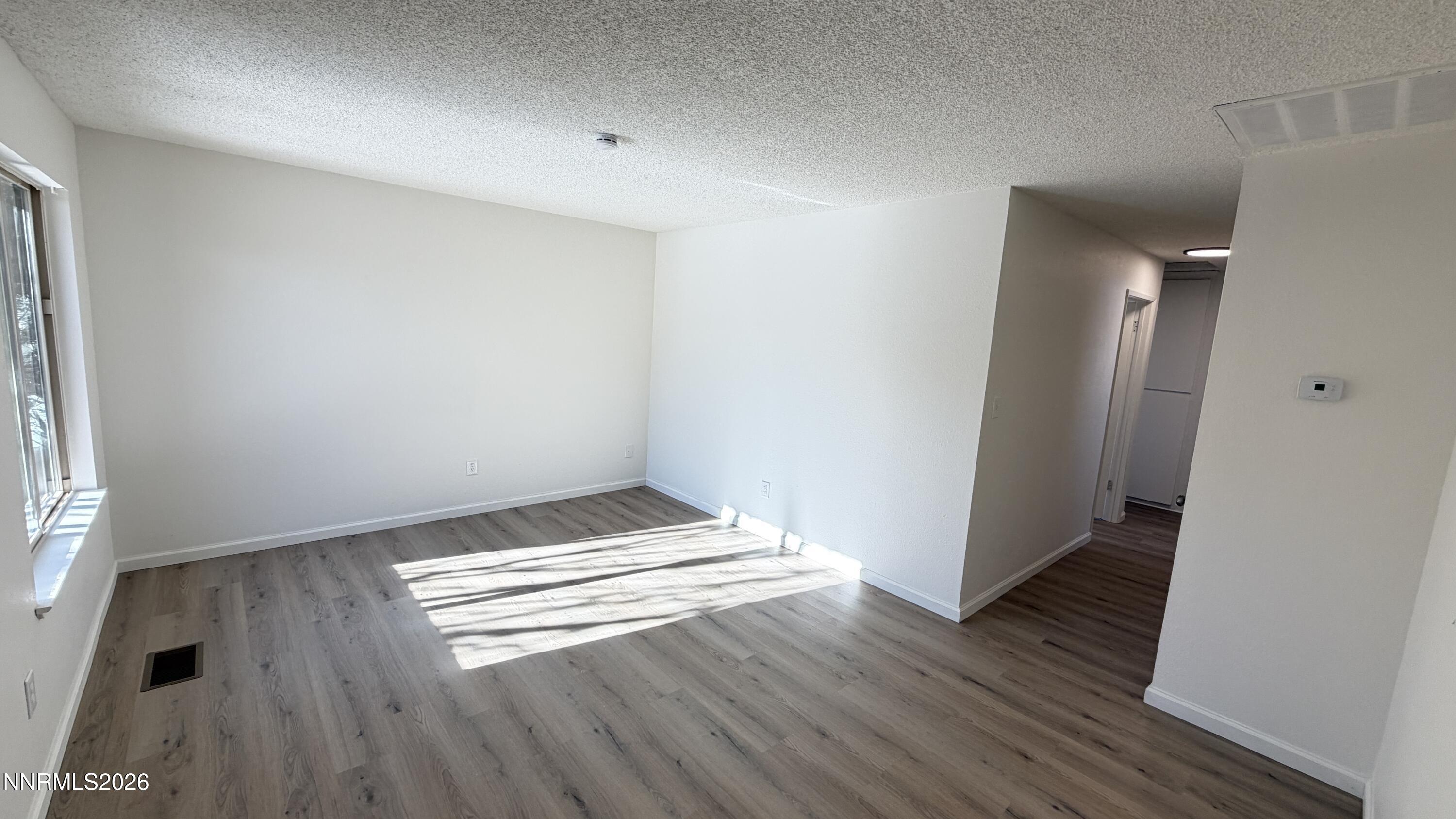 6451 Flower Street Reno, NV 89506 - Photo 2 of 14 an empty room with wooden floor