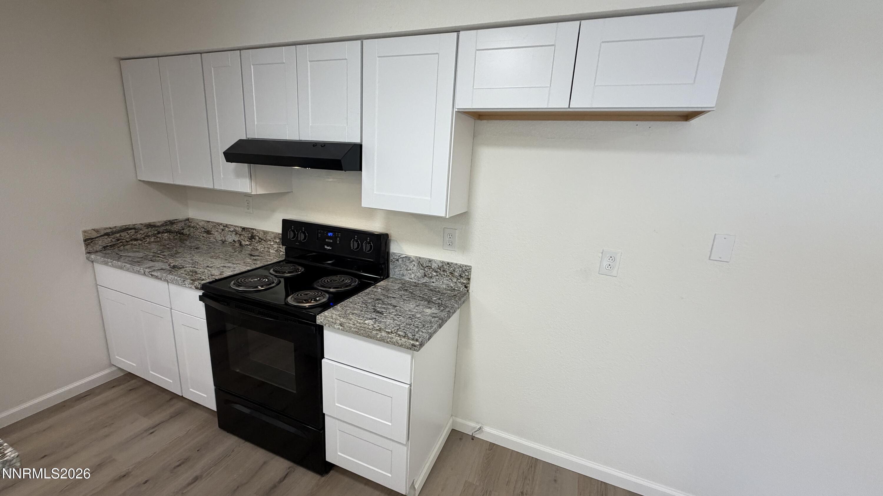 6451 Flower Street Reno, NV 89506 - Photo 3 of 14 a kitchen with a stove and a cabinets