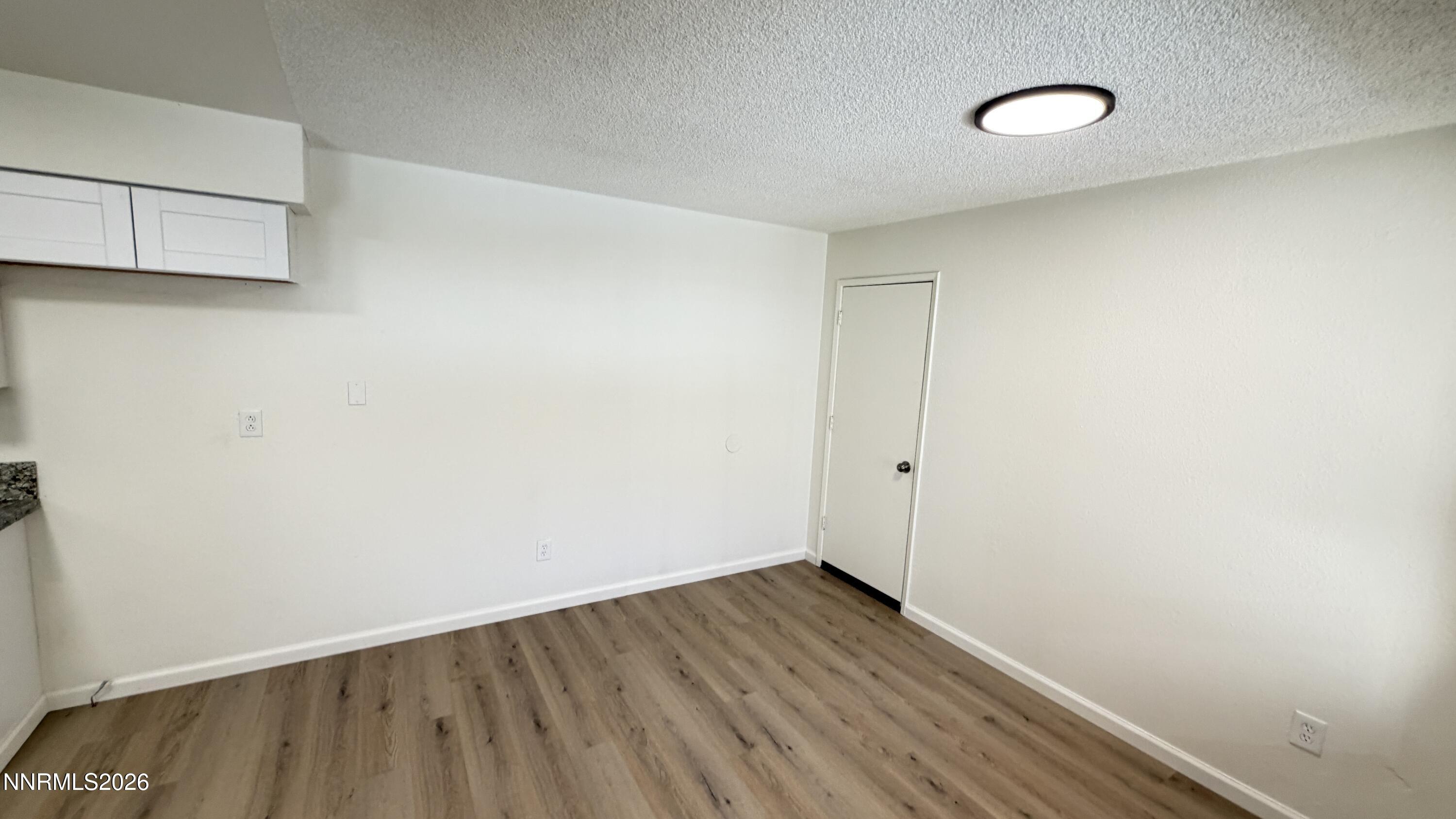 6451 Flower Street Reno, NV 89506 - Photo 6 of 14 a view of a room with wooden floor and white wall