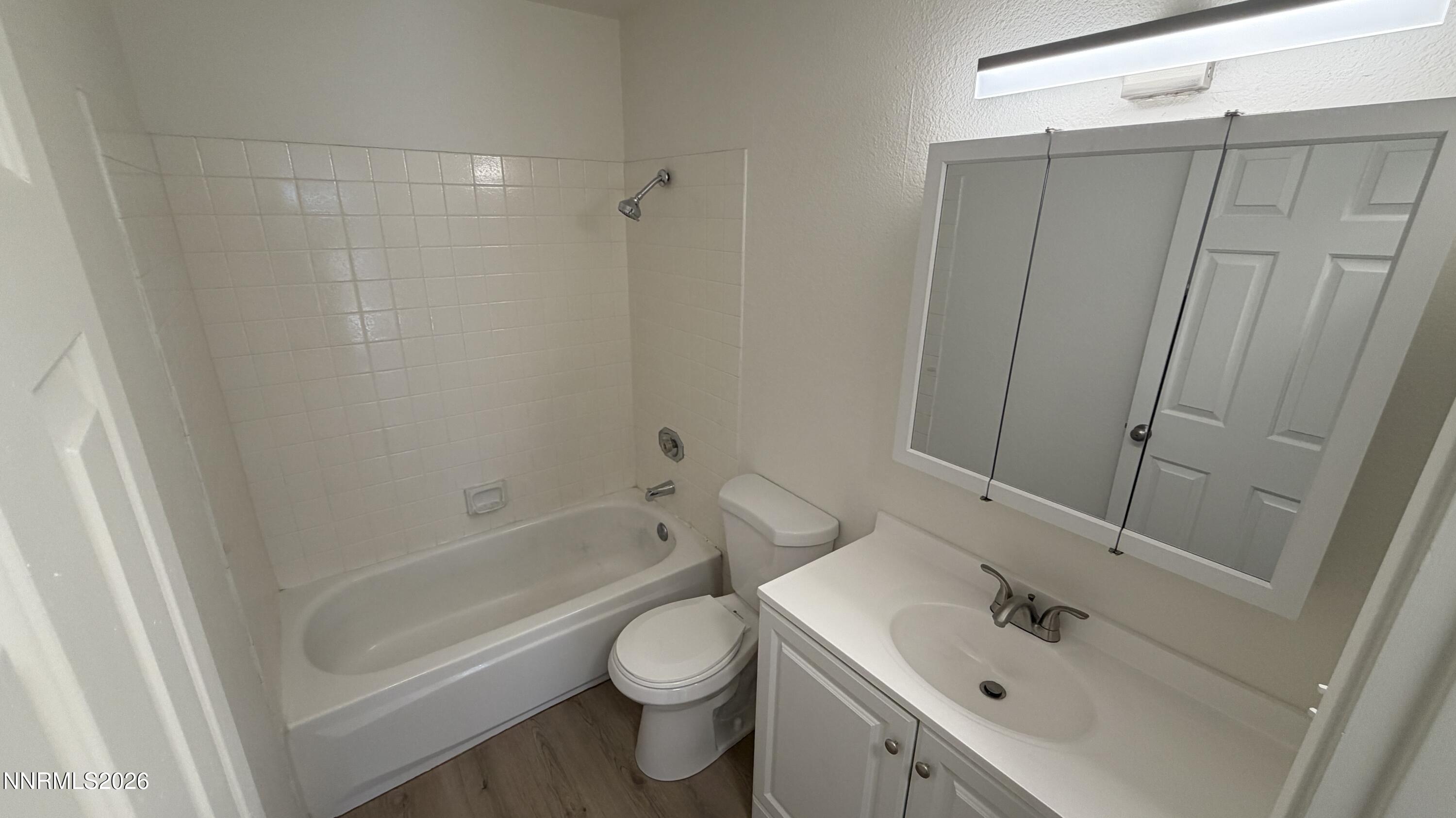 6451 Flower Street Reno, NV 89506 - Photo 8 of 14 a bathroom with a sink toilet and shower