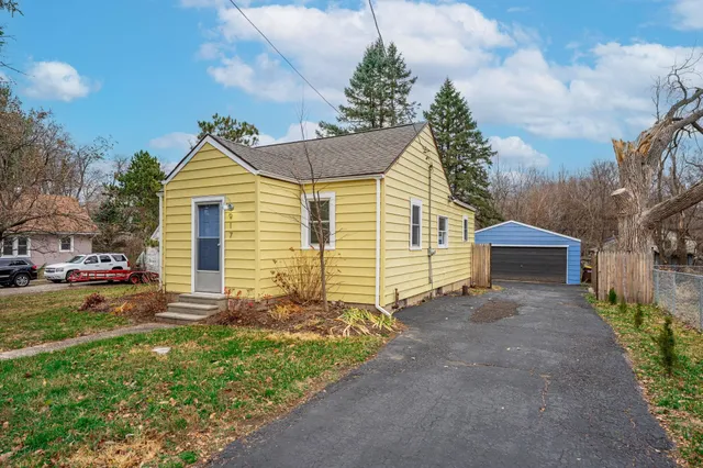 a view of a house with a yard and pathway