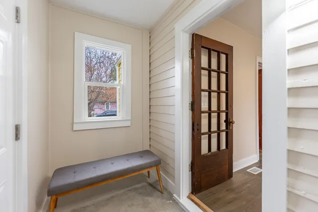 a hallway with a bookshelf and a window