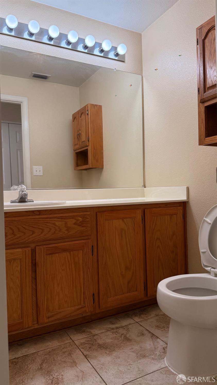 1804 Shadowcliff Way Brentwood, CA 94513 - Photo 16 of 34 a bathroom with a sink a toilet and mirror