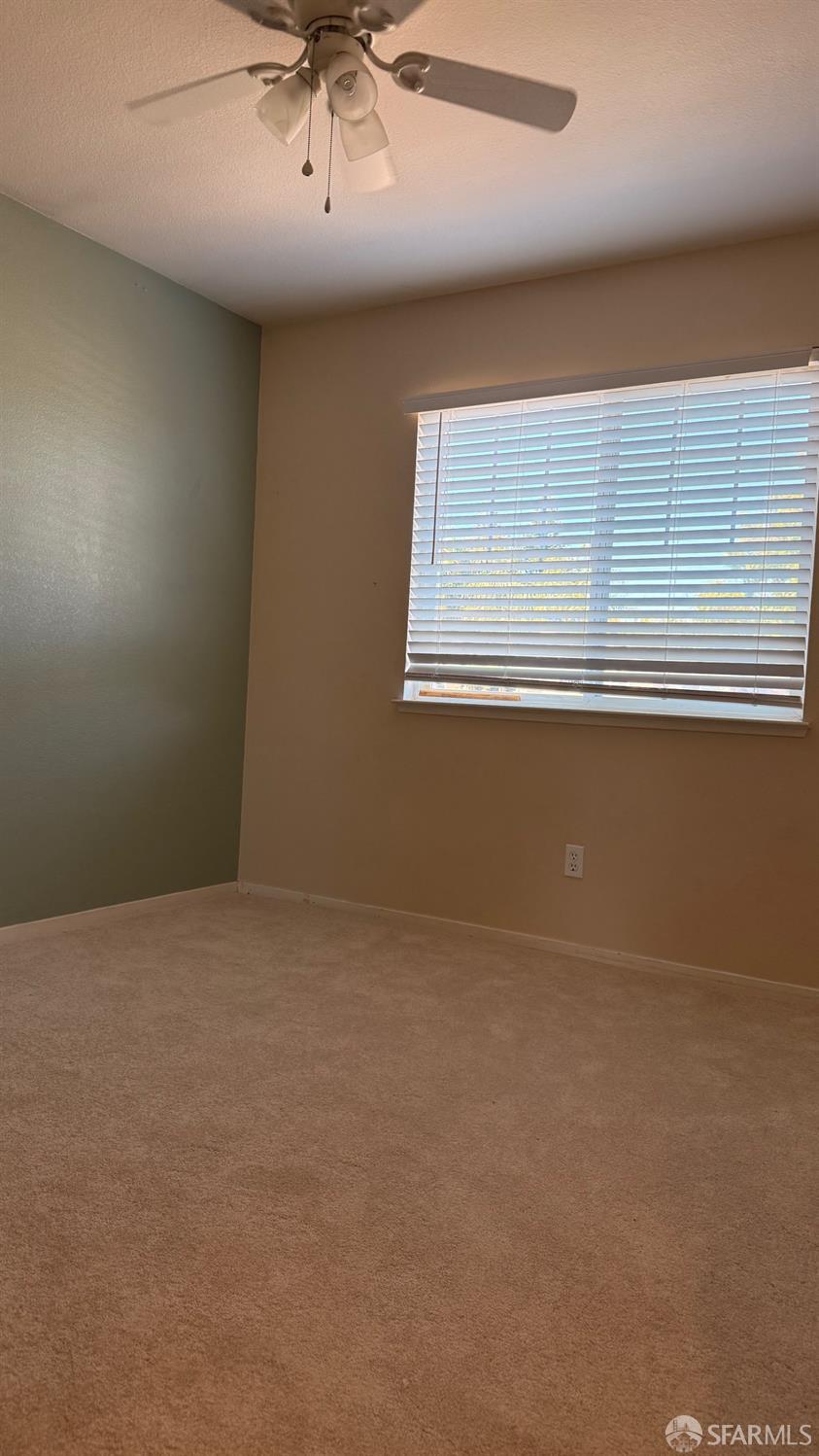 1804 Shadowcliff Way Brentwood, CA 94513 - Photo 20 of 34 an empty room with a ceiling fan and window